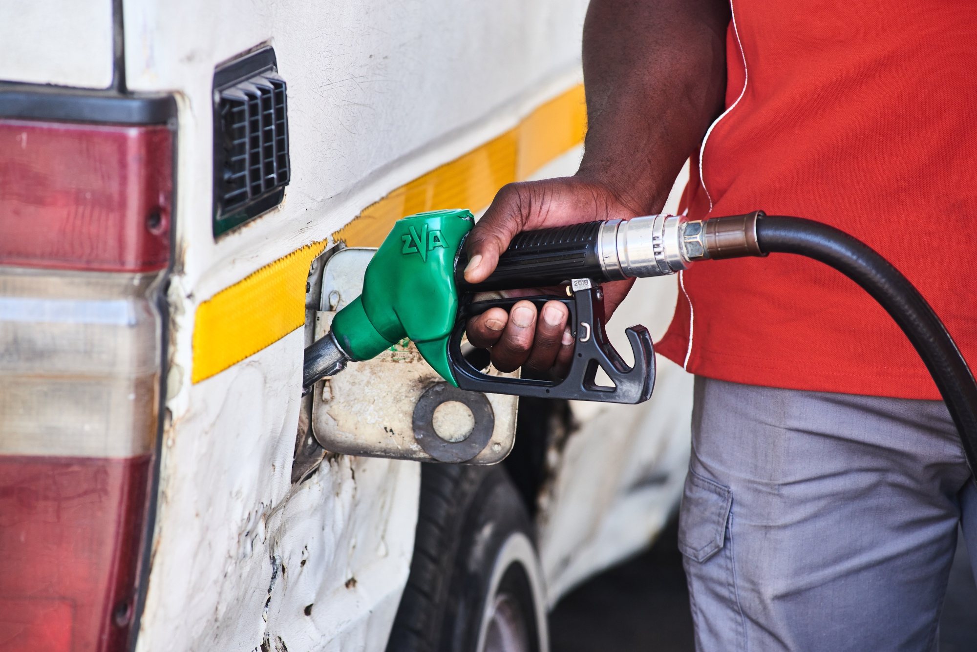 A worker refuels a vehicle at a Shell Plc gas station, which has operated for 102 years, in the Alberton district of Johannesburg, South Africa, on Thursday, May 9, 2024. Shell plans to divest from its fuel-supply businesses in South Africa, a process set in motion years ago when it shut the biggest oil refinery in the country. Photographer: Waldo Swiegers/Bloomberg
