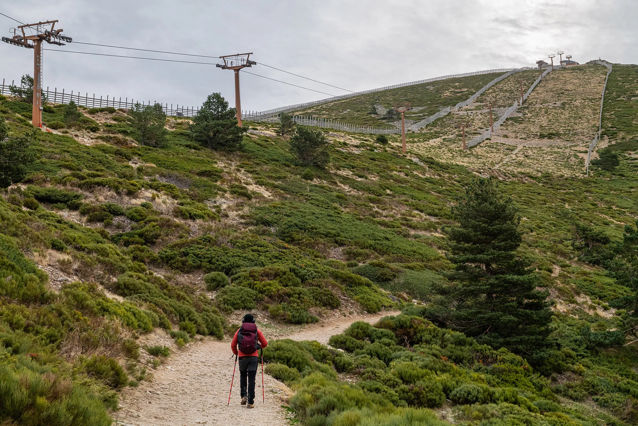 A hiker negotiates&nbsp;a trail alongside a&nbsp;ski lift&nbsp;in the&nbsp;resort of Navacerrada, close to Madrid, Spain.