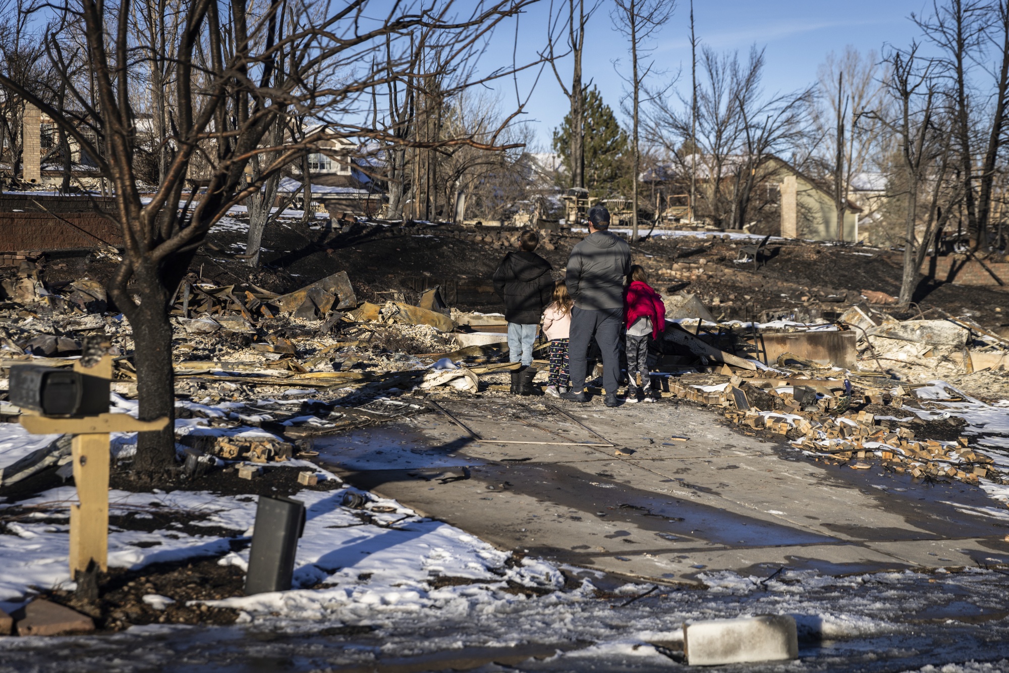 Residents survey remains of homes that were burned during the Marshall Fire in Superior, Colorado, in Boulder County, on Jan. 2, 2022. Photographer: Chet Strange/Bloomberg
