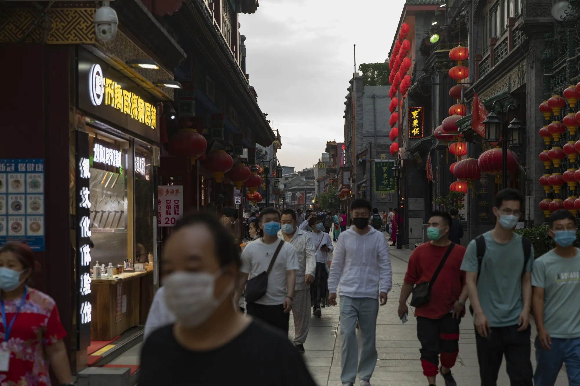 Pedestrians walk through the Qianmen area of Beijing on May 20.