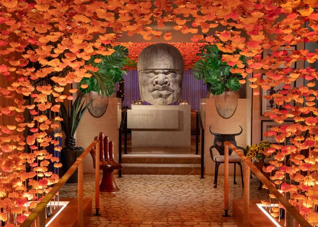 Orange flowers create a tunnel into the entrance of Casa Playa.