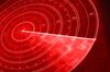 Detail of a red military radar screen with glowing coordinates and positioning numbers. Scanner axis is visible while spinning around the center. Field is empty and no objects are detected. Diminishing perspective and selective focus.