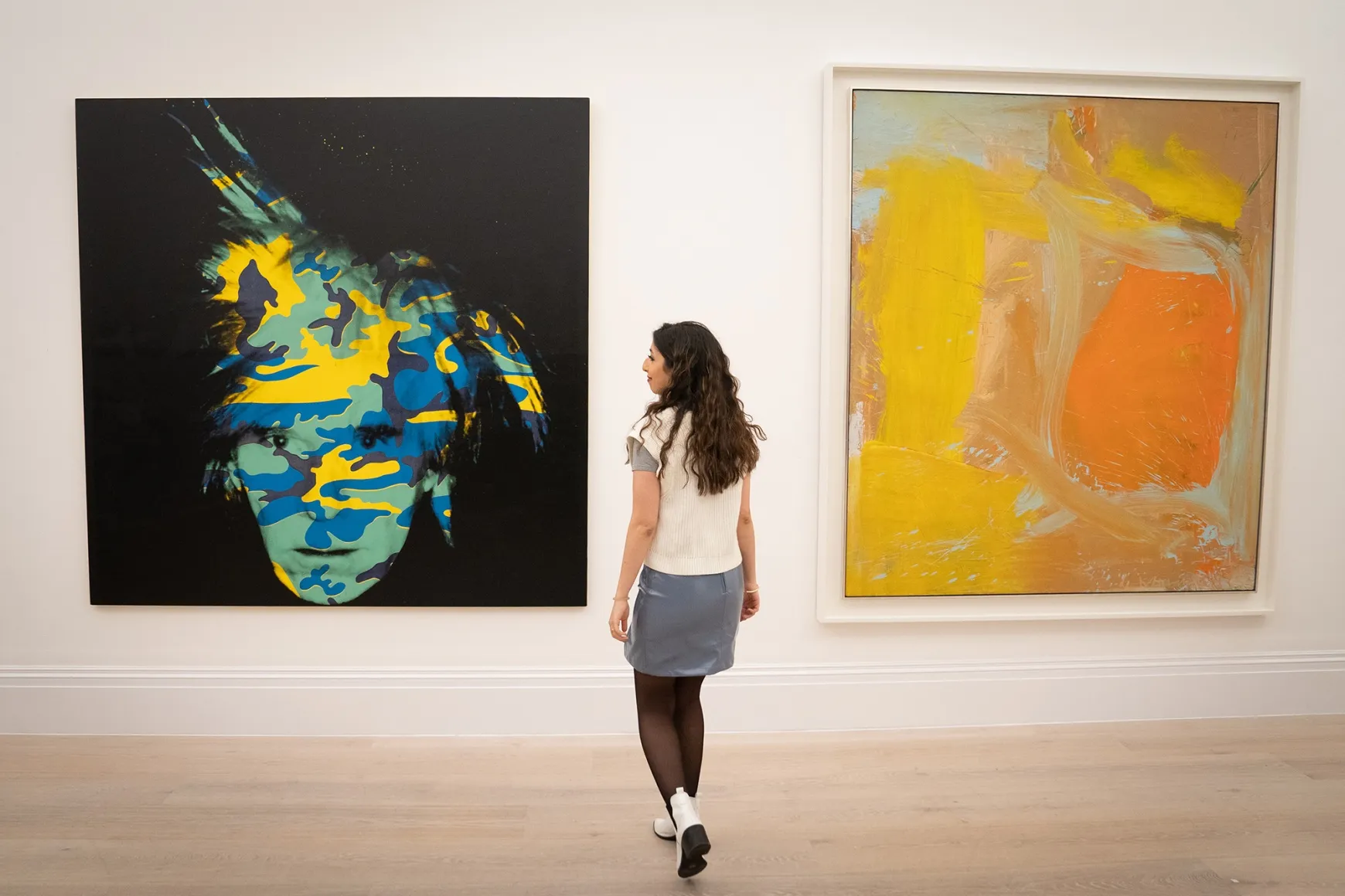 Andy Warhol’s Self-Portrait (left) and Willem de Kooning’s Untitled (right) at Sotheby's in London prior to being offered at auction in New York.