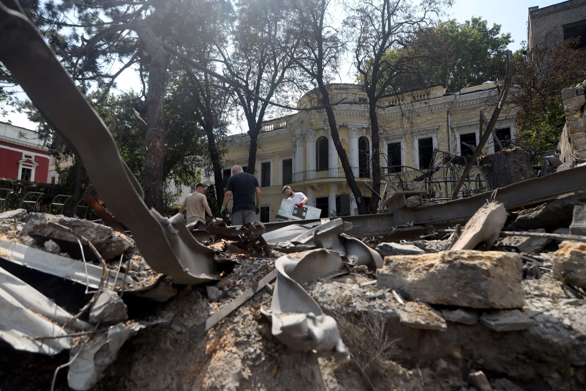 Workers clear rubble following a Russian missile strike in the center of Odesa.