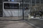 Pedestrians pass in front of Blackstone Group LP headquarters in New York, U.S.