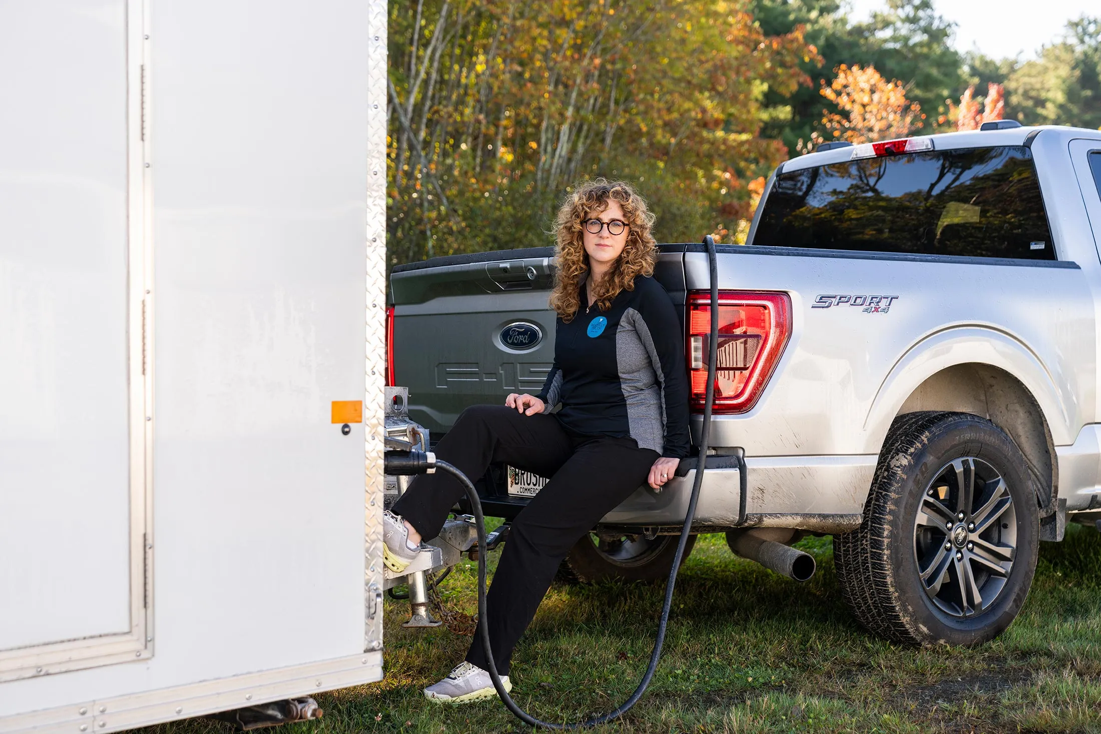 Amber Lombardi with her Ford F-150 hybrid in Falmouth, Maine. She uses the pickup to tow the trailer for her mobile dental practice, called Mainely Teeth.