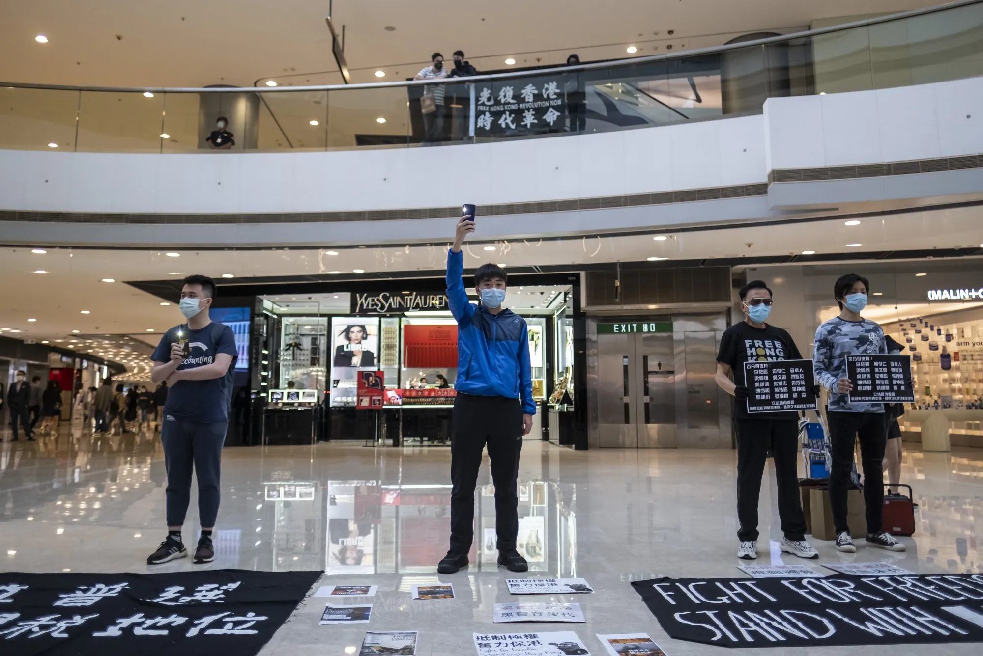 Demonstrators stand&nbsp;spaced apart during a protest at the International Finance Center (IFC) Mall in the Central district of Hong Kong, April 24.