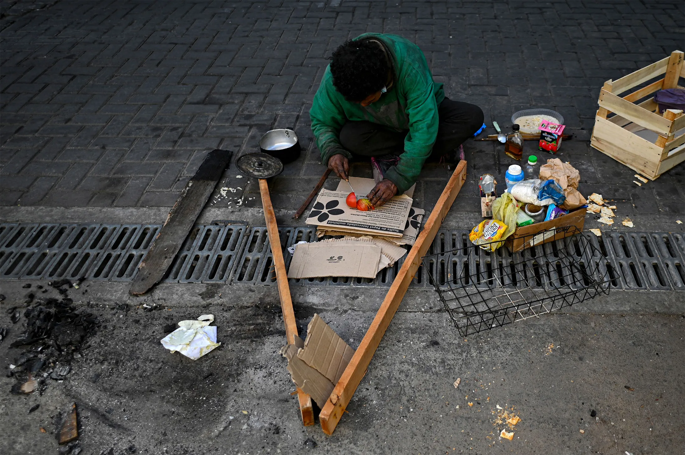 A homeless man prepares a meal on a street in Buenos Aires in September&nbsp;2022.&nbsp;