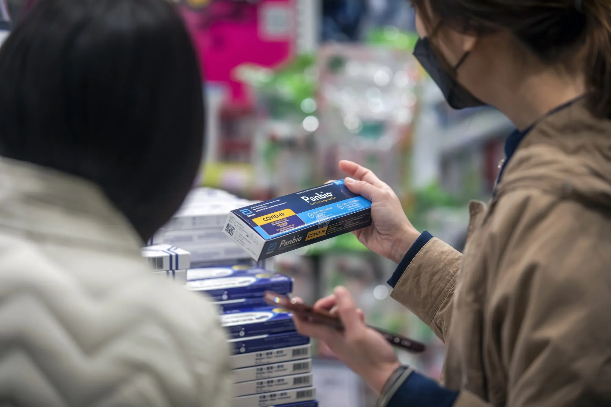 A customer browses an Abbott Laboratories Panbio Covid-19 rapid antigen test kit at a store in Hong Kong.