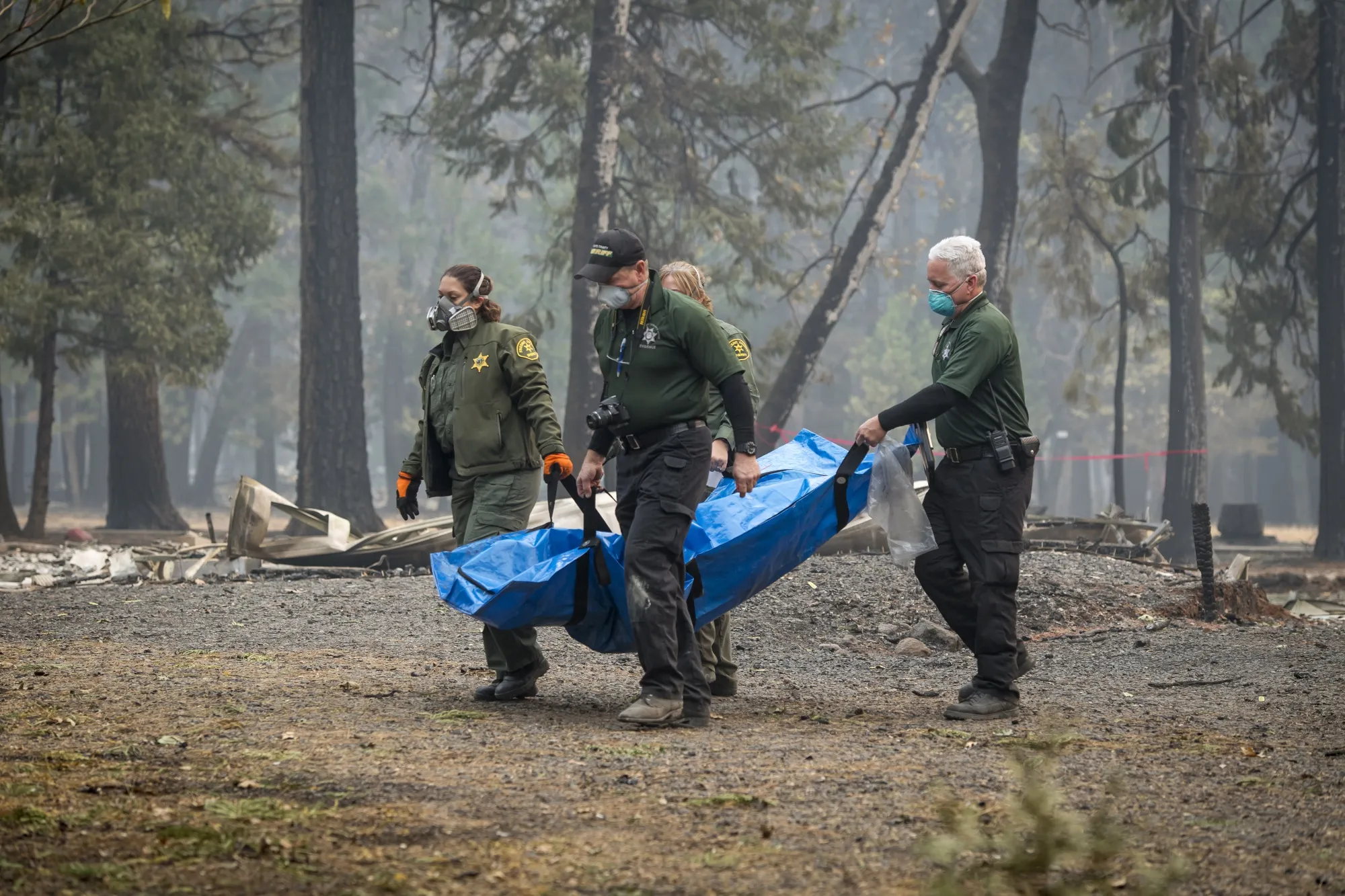 Officers remove the remains of a victim of the Camp Fire in Magalia, California, on Nov. 15, 2018.