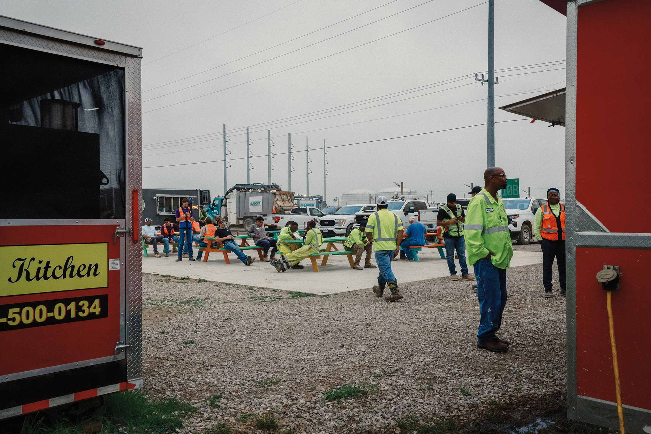 People seated at picnic benches during lunchtime outside Meta’s construction site. The influx of new workers has bolstered local businesses while also driving up rents.