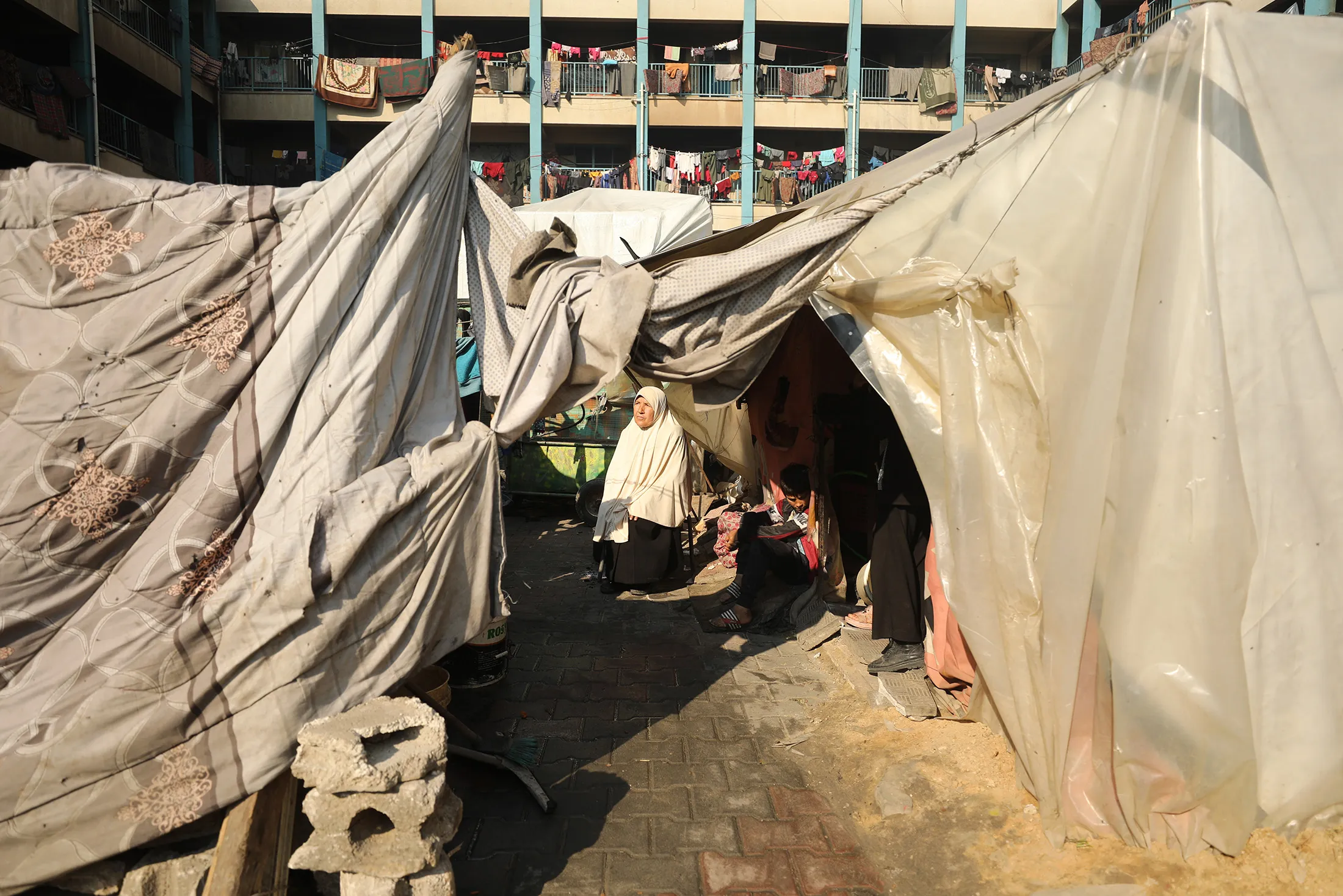 A Palestinian woman sits among makeshift tents at the Jabalia Refugee Camp in Gaza on Feb.&nbsp;26.
