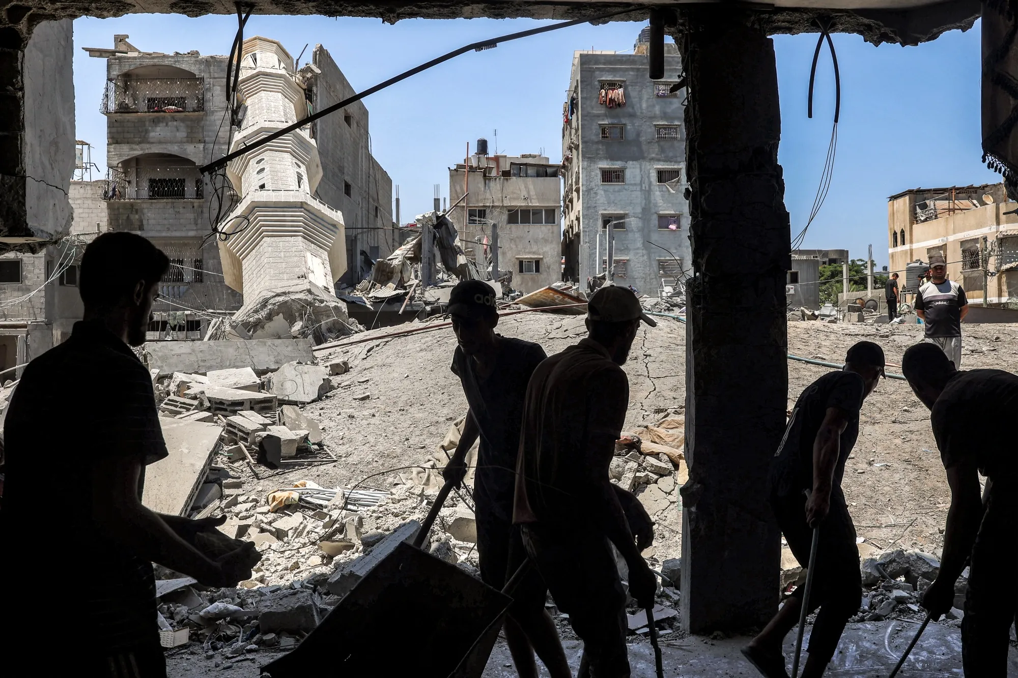 People search the rubble of destroyed buildings following Israeli bombardment in Nuseirat in the Gaza Strip.