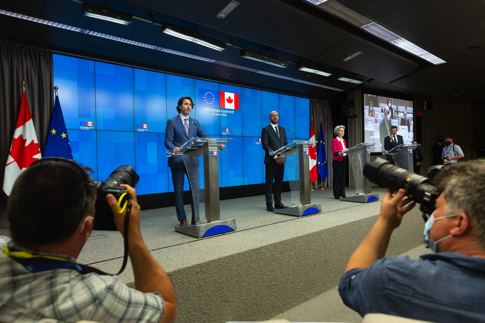 Justin Trudeau, left, Charles Michel, and Ursula von der Leyen speak following an EU and Canada summit in Brussels, on June 15.