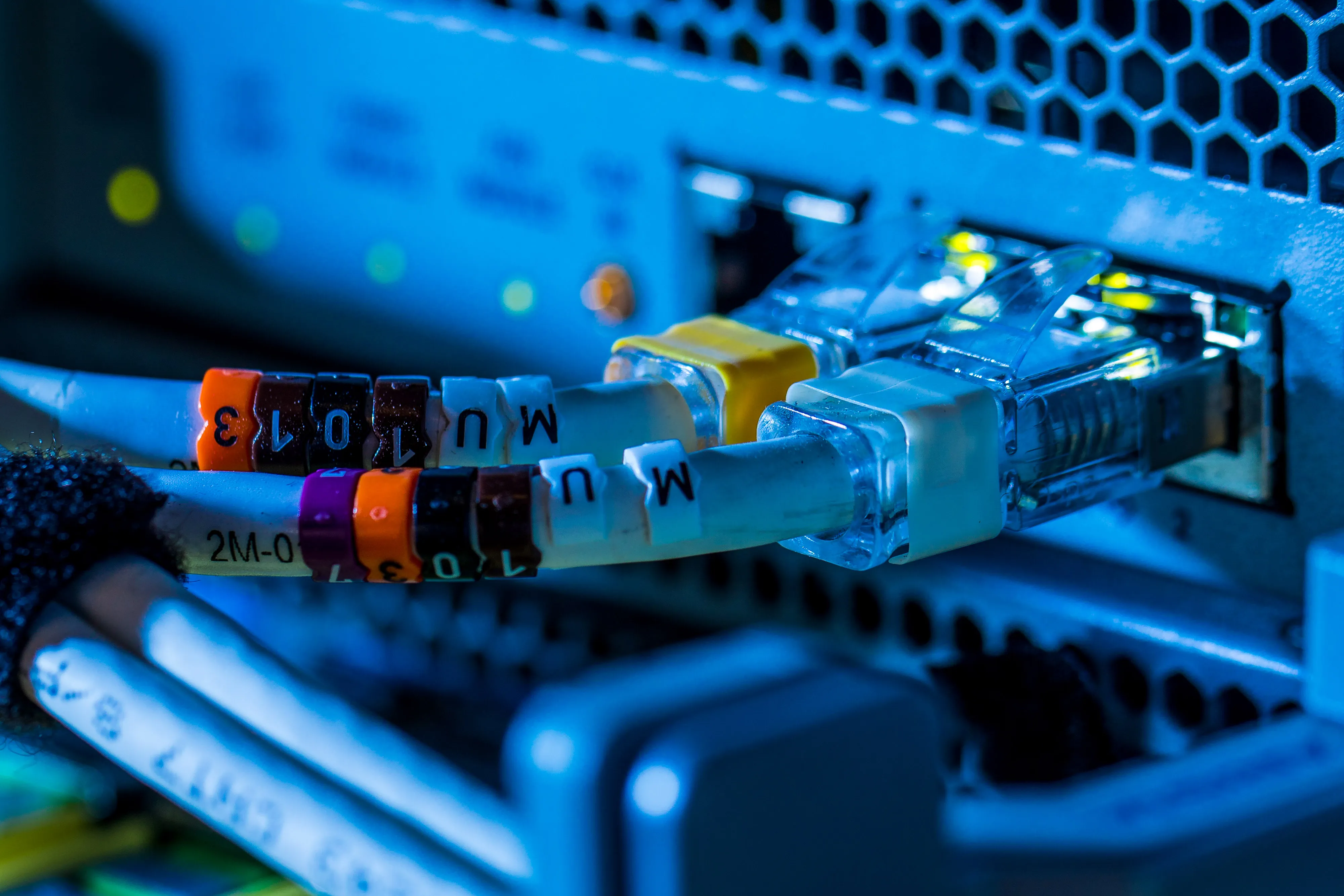 Clip on cable markers sit around network cables inside a communications room at an office in London, U.K., on Monday, May 21, 2018. The Department of Culture, Media and Sport will work with the Home Office to publish a white paper later this year setting out legislation, according to a statement, which will also seek to force tech giants to reveal how they target abusive and illegal online material posted by users.