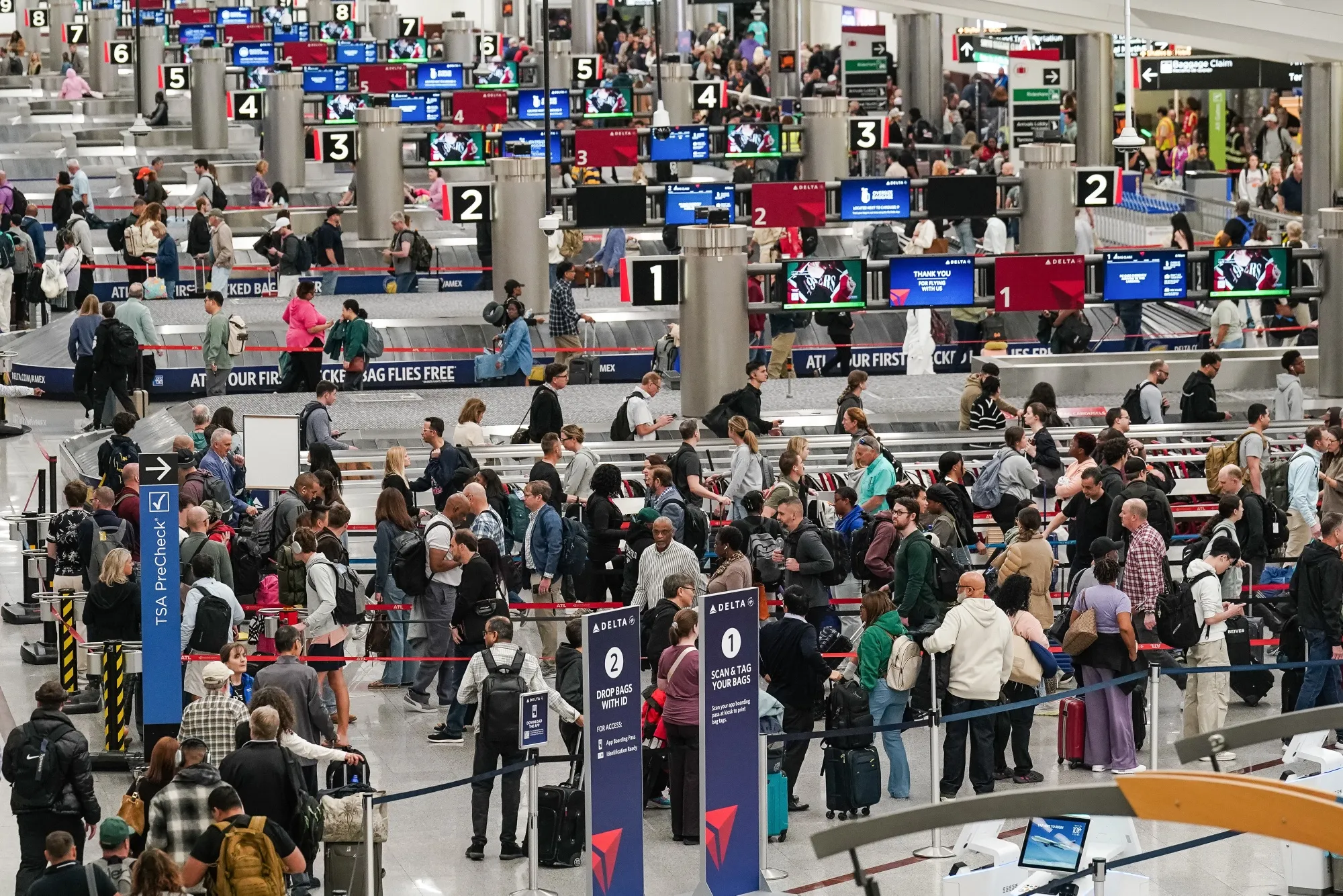 Travelers wait in line at a Transportation Security Administration (TSA) checkpoint at Hartsfield-Jackson Atlanta International Airport (ATL) in Atlanta on March 27.