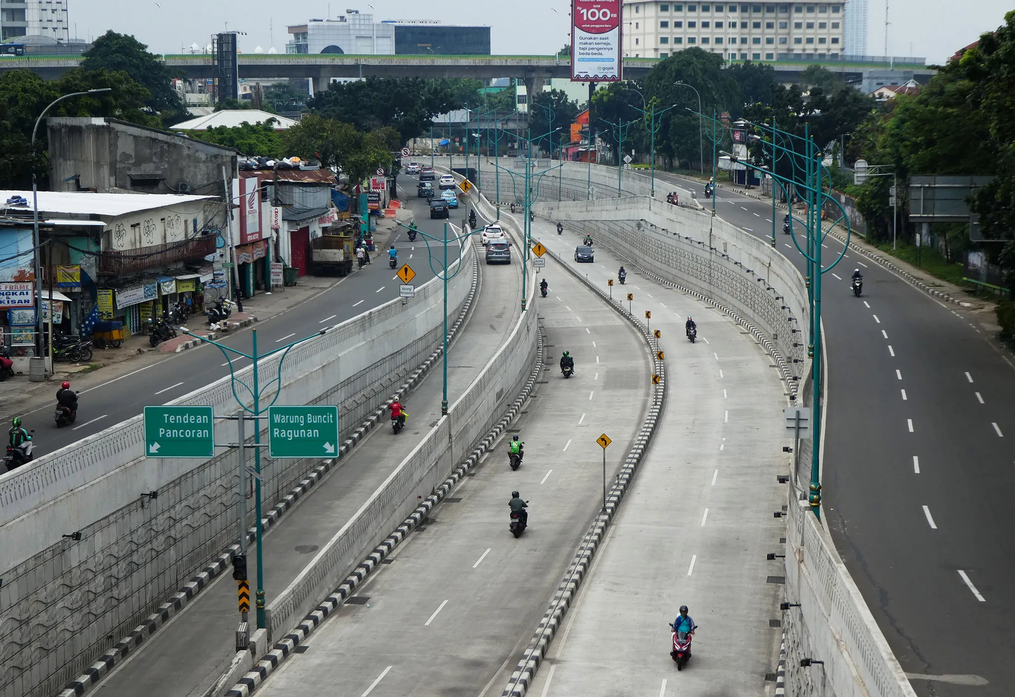 Motorists commute on a usually busy road in downtown Jakarta.