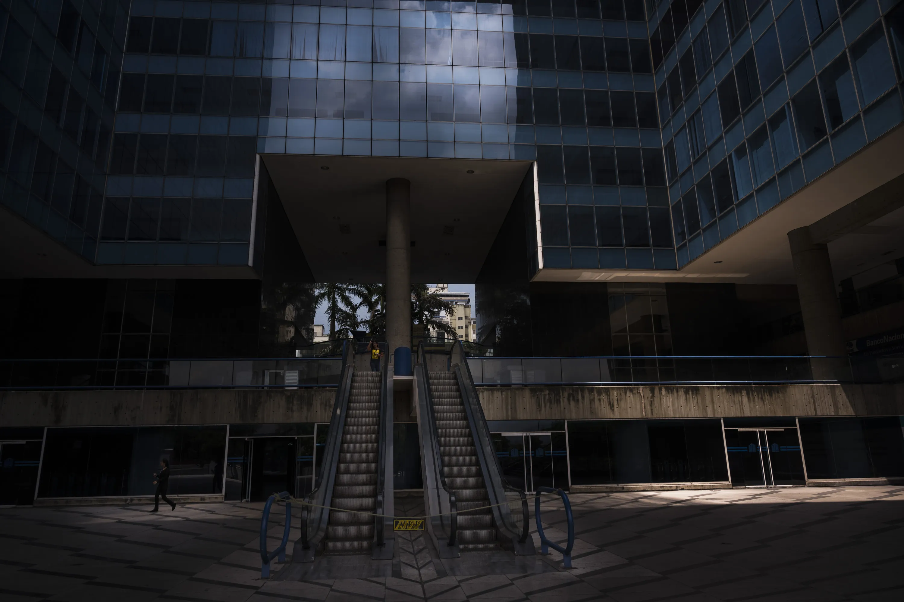 Escalators stand closed in front of a business center during a power outage in Caracas on March 26.