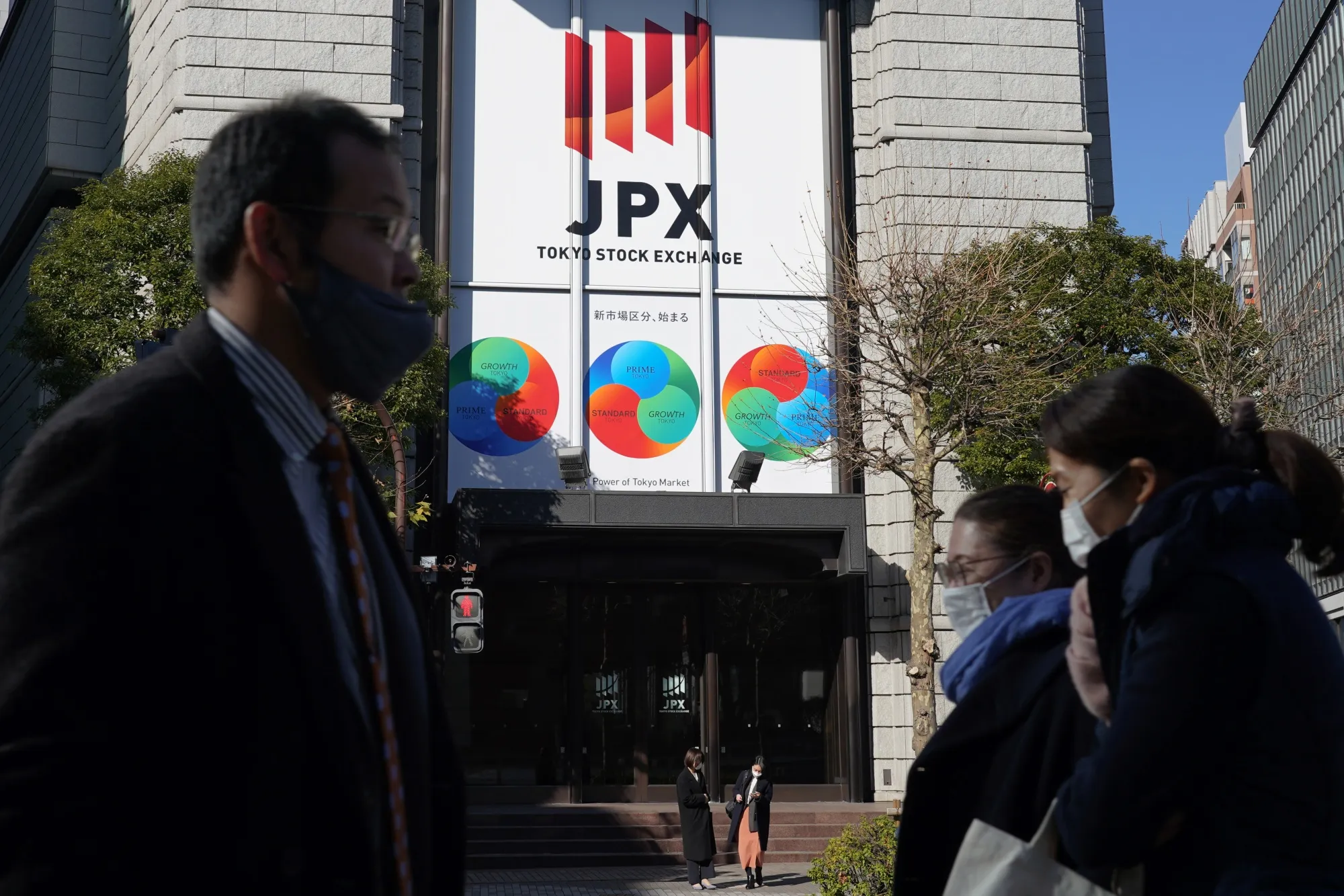 Pedestrians walk past the Tokyo Stock Exchange&nbsp;in Tokyo, Japan.