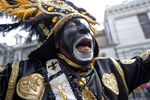 A member of the Krewe of Zulu marches during their parade Mardi Gras day in New Orleans.