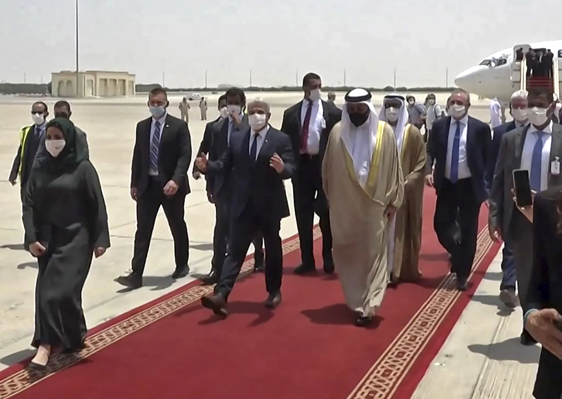 Yair Lapid, center left, arrives to the&nbsp;Abu Dhabi airport on June 29.&nbsp;