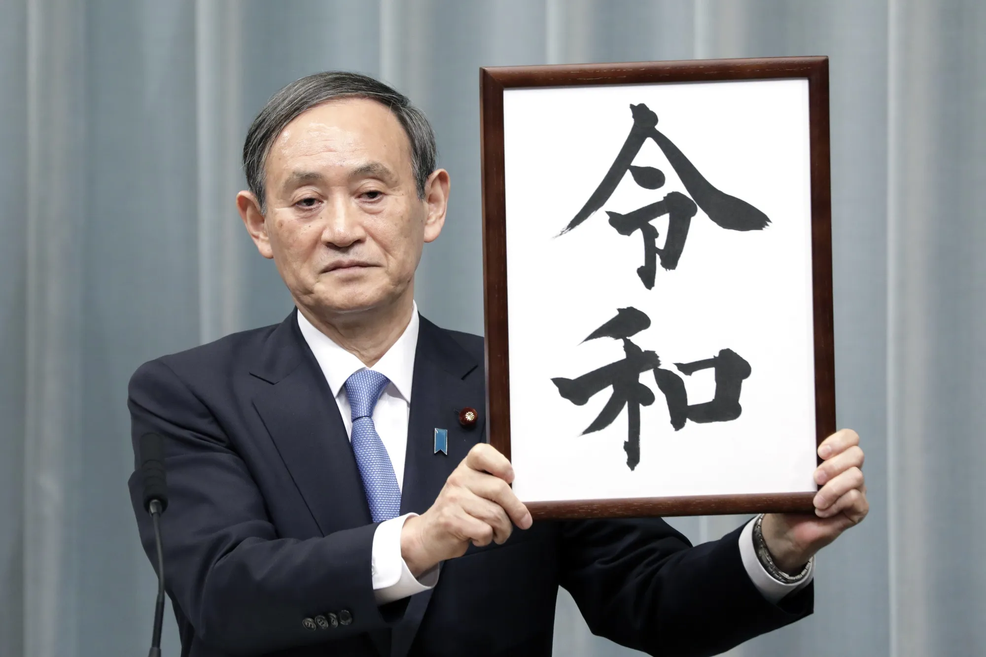 Yoshihide Suga unveils the name of Japan's next imperial era "Reiwa" on April 1.