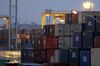 Containers sit stacked at a shipping terminal at dusk in Yokohama, Japan, on Thursday, July 11, 2019. Japan and South Korea plan to meet on Friday over Tokyo’s move to restrict vital exports to its neighbor, but neither has much political incentive to climb down from their worst dispute in decades.