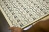 Stacks of 2017 50 subject uncut sheets of $1 dollar notes bearing the name of U.S. Treasury Secretary Steven Mnuchin sit in a machine at the U.S. Bureau of Engraving and Printing in Washington, D.C., U.S., on Wednesday, Nov. 15, 2017. A change in the Senate tax-overhaul plan that would expand a temporary income-tax break for partnerships, limited liability companies and other so-called "pass-through" businesses won the endorsement of a national small-business group today.