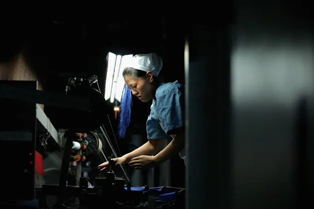 A worker controls the production line of textile at Babei Group in Shengzhou, Zhejiang province, China