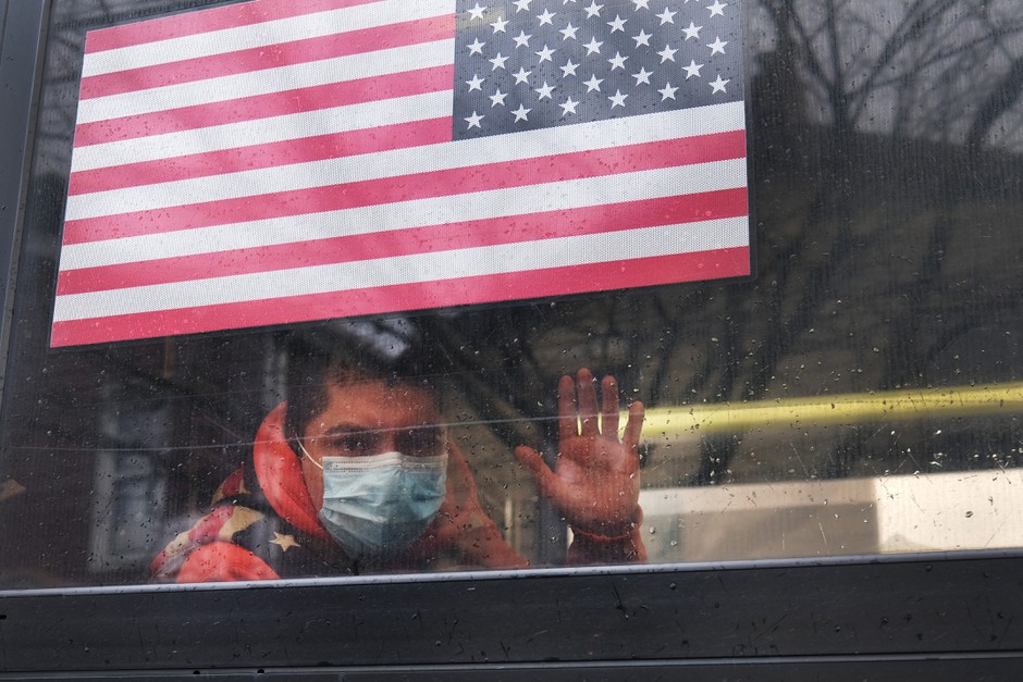 A rider waves from an MTA bus in Queens, New York, epicenter of the coronavirus outbreak in the United States.