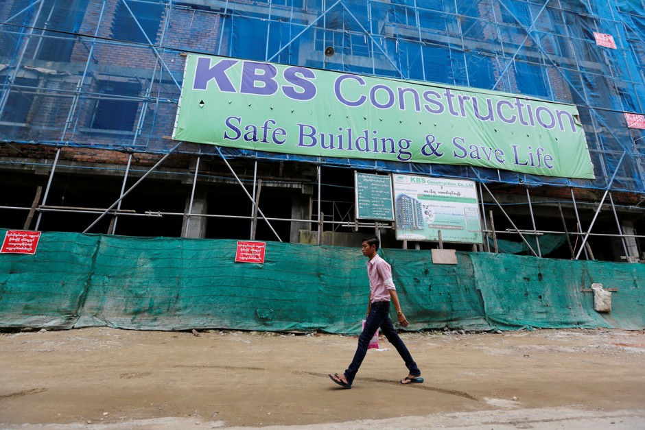 A man walks by construction halted by the government in Yangon.