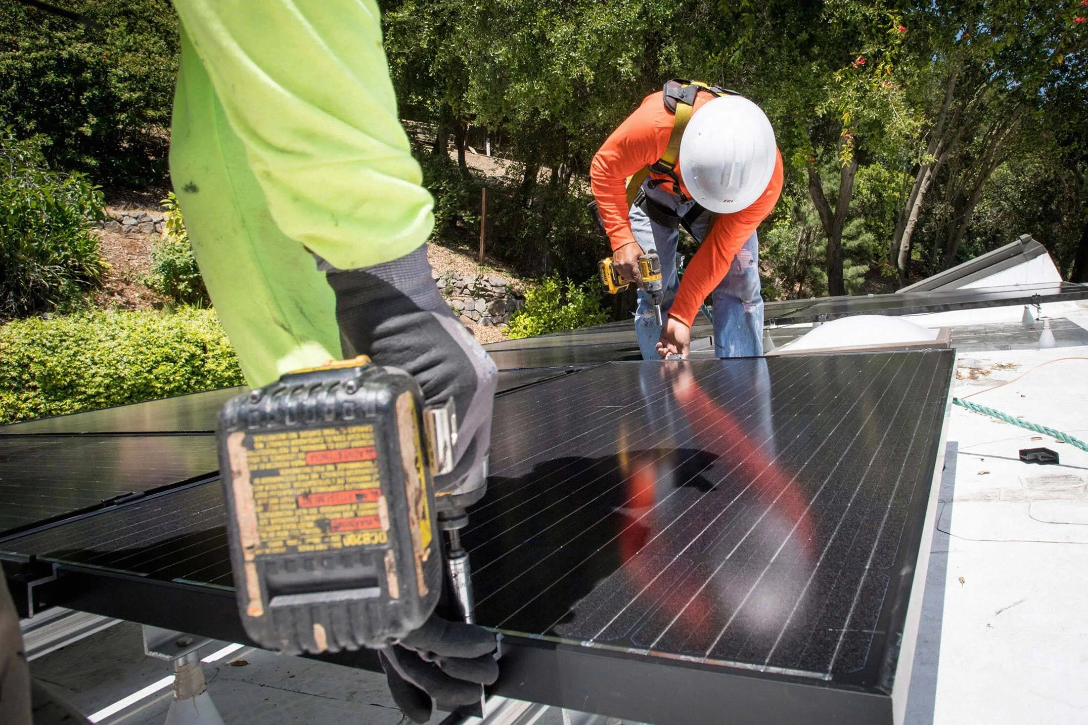 Petersen Dean Inc. employees install solar panels on the roof of a home in Lafayette, Calif., on May 15, 2018.&nbsp;