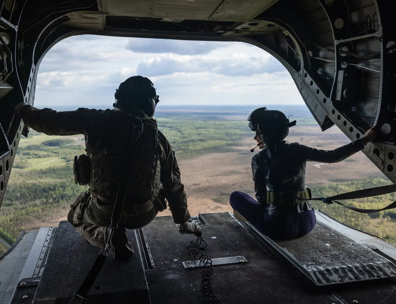 Estonian Prime Minister Kaja Kallas, right, flying back from NATO's Spring Storm exercise on a British Chinook helicopter on May 15.