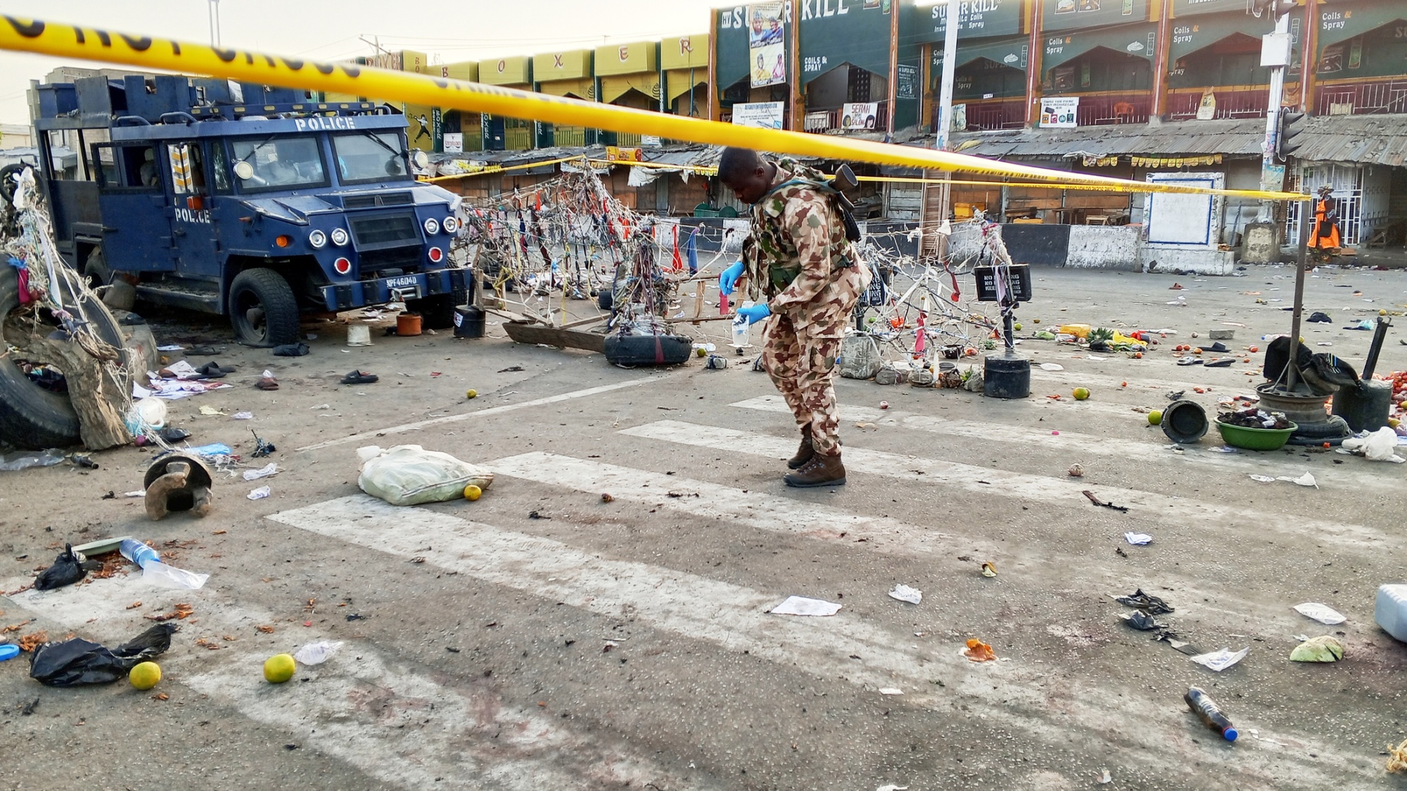 A soldier inspects the scene of a bomb blast in Maiduguri, Nigeria, on March 17