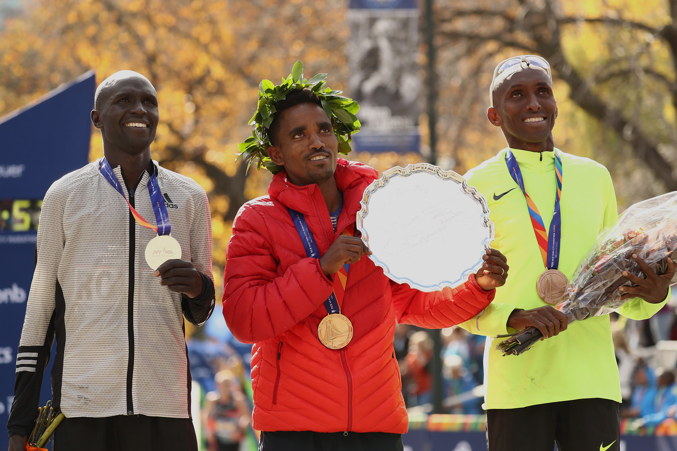 First-place finisher Ghirmay Ghebreslassie of Eritrea, center, second-place finisher Lucas Rotich of Kenya, left, and third-place finisher Abdi Abdirahman of the United States, right.