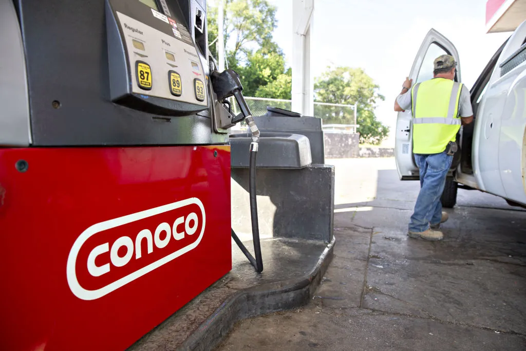 A customer returns to his vehicle after making a purchase at a ConocoPhillips gas station in Peoria, Illinois, U.S., on Tuesday, July 24, 2018. ConocoPhillips is scheduled to release earnings figures on July 26.