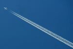 A passenger airplane leaves a trail thro