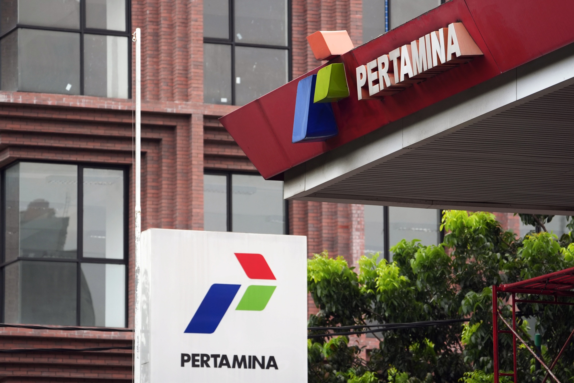 The PT Pertamina logos displayed at a gas station in Jakarta, Indonesia, on Thursday, Sept. 4, 2025. Shell Plc and BP Plc-branded gas stations in Indonesia have run low on fuel as supplies are curbed by import restrictions. Photographer: Dimas Ardian&#x2F;Bloomberg