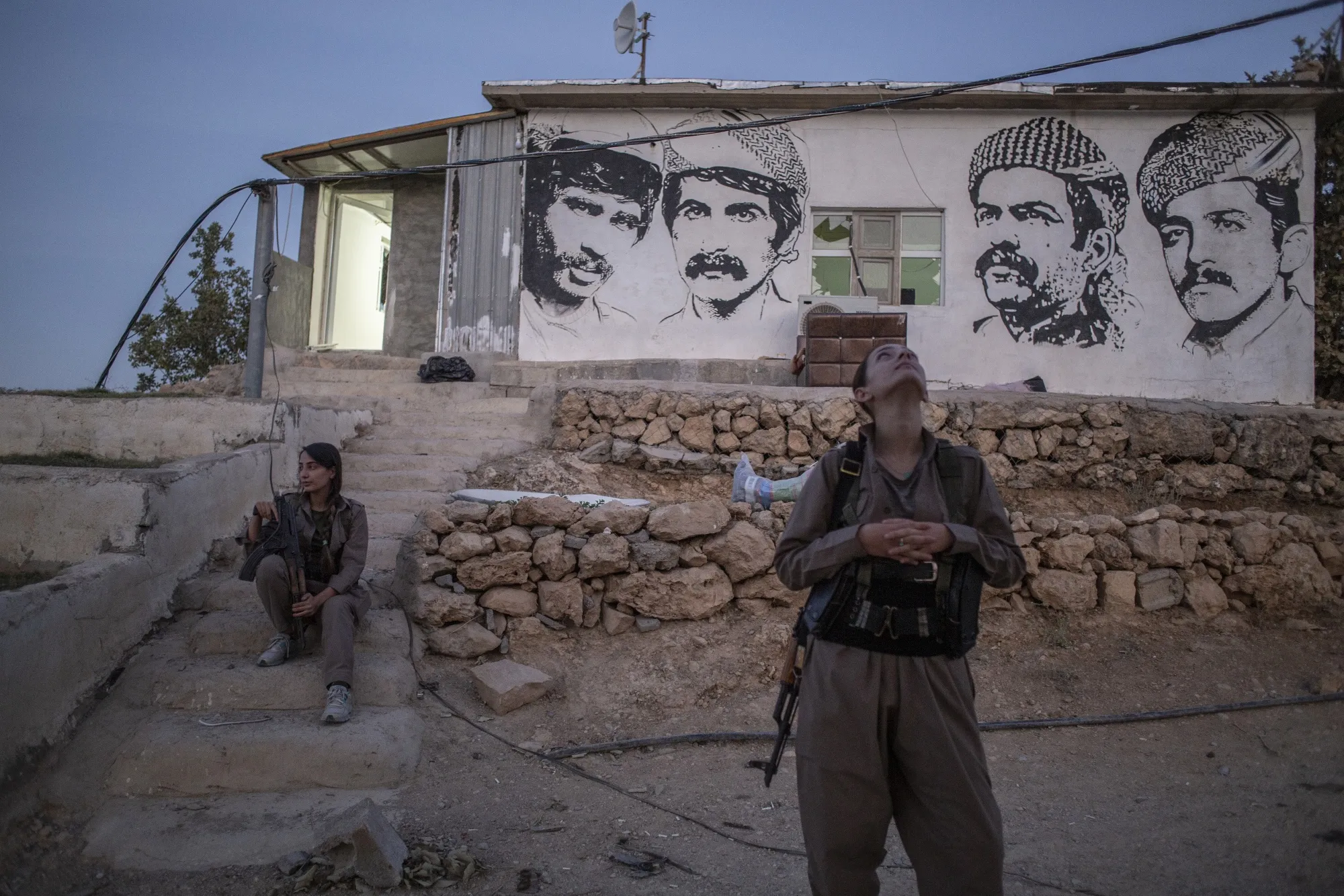 A member of the Komala of Revolutionary Toilers of Iranian Kurdistan watches for drones&nbsp;in Sulaymaniyah, Iraq, on Oct. 3.&nbsp;