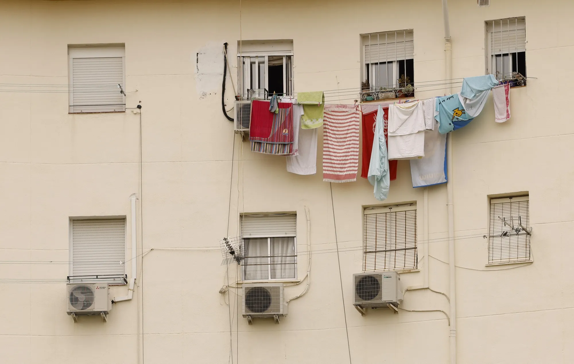 Air conditioning units on residential building during a heat wave in Seville.