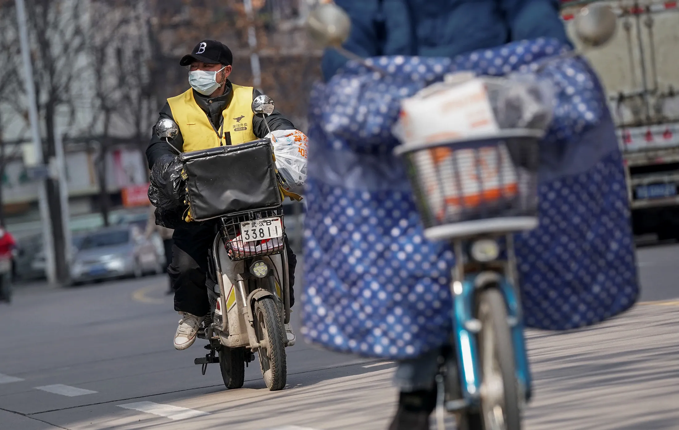 A courier delivers goods in Jiang'an District of Wuhan&nbsp;on Feb. 9.