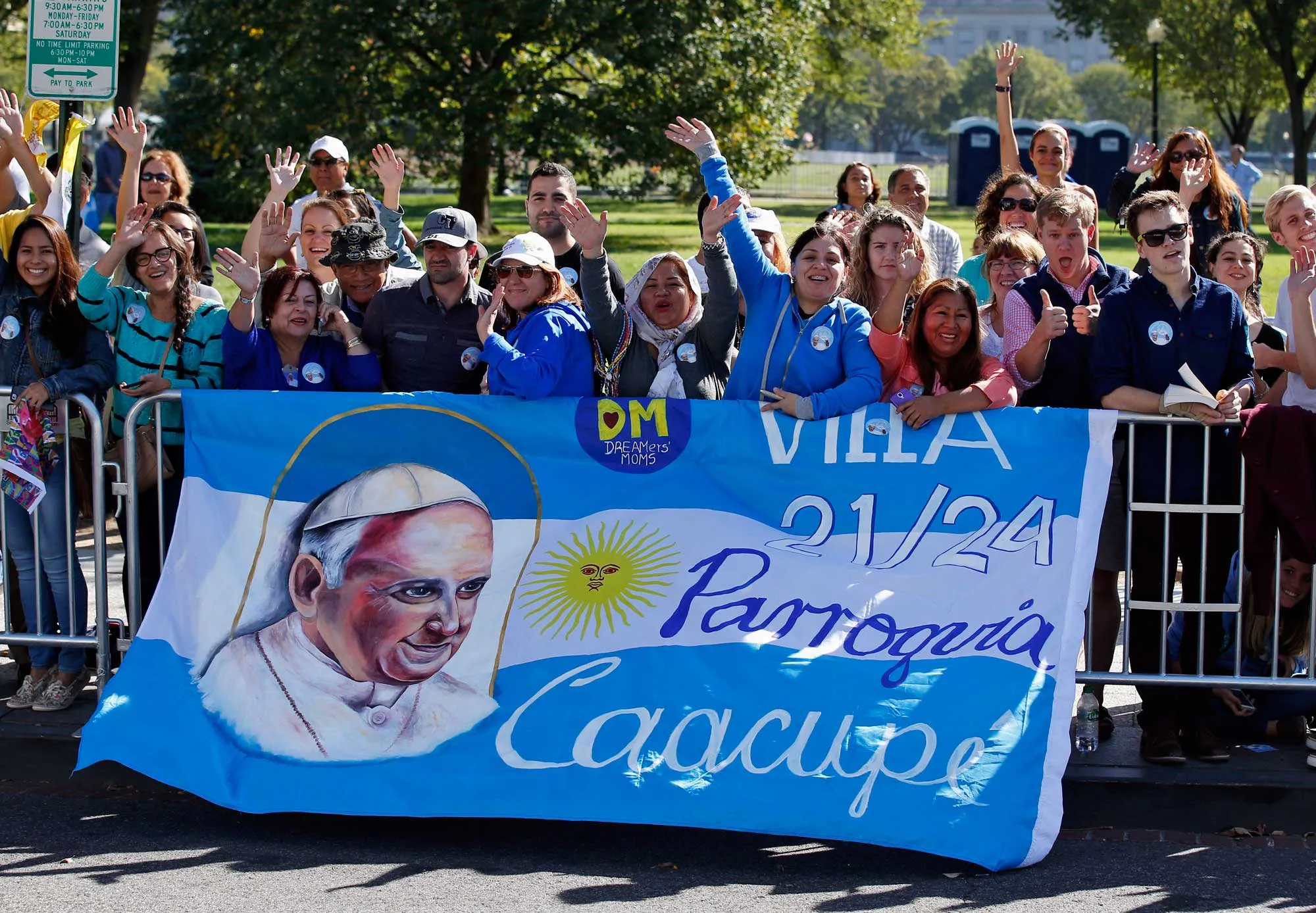 People wave and cheer on the parade route for Pope Francis on Sept. 23, 2015, in Washington.
