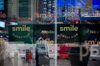Monitors display SmileDirectClub Inc. signage as pedestrians are reflected in a window during the company's initial public offering (IPO) at the Nasdaq MarketSite in New York, U.S., on Thursday, Sept. 12, 2019. SmileDirectClub Inc. shares declined 12% from their initial public offering price in Thursday's debut.