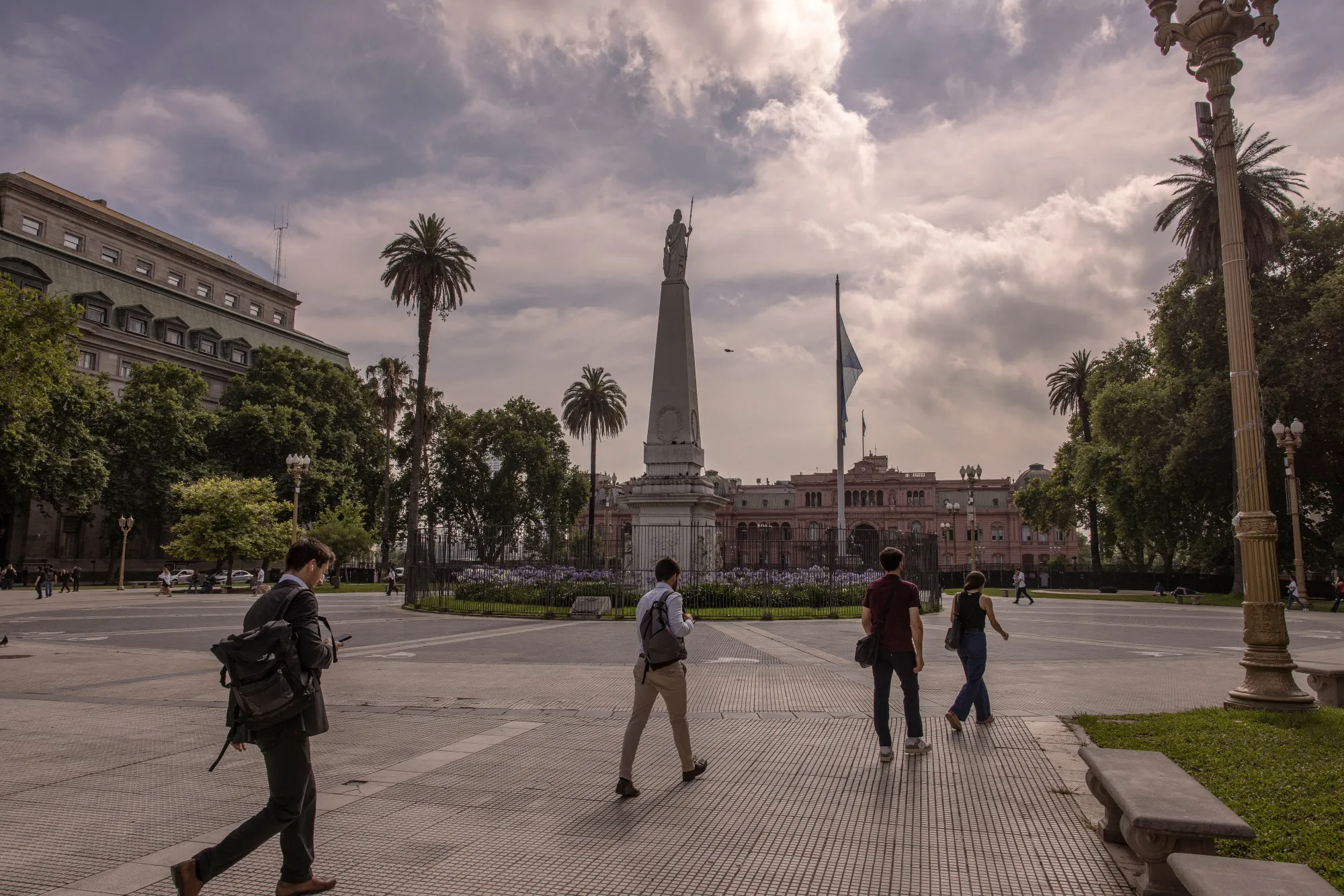 Pedestrians walk through Plaza de Mayo in Buenos Aires.&nbsp;Argentine bonds rallied Tuesday in tandem with Ecuadorian debt, extending recent gains.