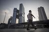 A pedestrian walks past Tencent Holdings Ltd.'s new under construction headquarters, left, in Shenzhen, China, on Monday, Aug. 22, 2016. The new headquarters for Tencent is a $599 million project aimed at creating a campus-like atmosphere for the urban setting. Scheduled for completion next year, the Shenzhen skyscraper could become one of the largest labs for new internet services and connected devices.