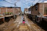 A resident walks along a flooded street after heavy rains caused by Cyclone Yaku north of Trujillo in La Libertad Department, Peru on March 13.
