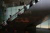 A sign for Starbucks Corp. is reflected as morning commuters ascent on an escalator in Tokyo, Japan, on Monday, May 14, 2018. Japan is scheduled to release its first-quarter gross domestic product (GDP) figures on May 16.