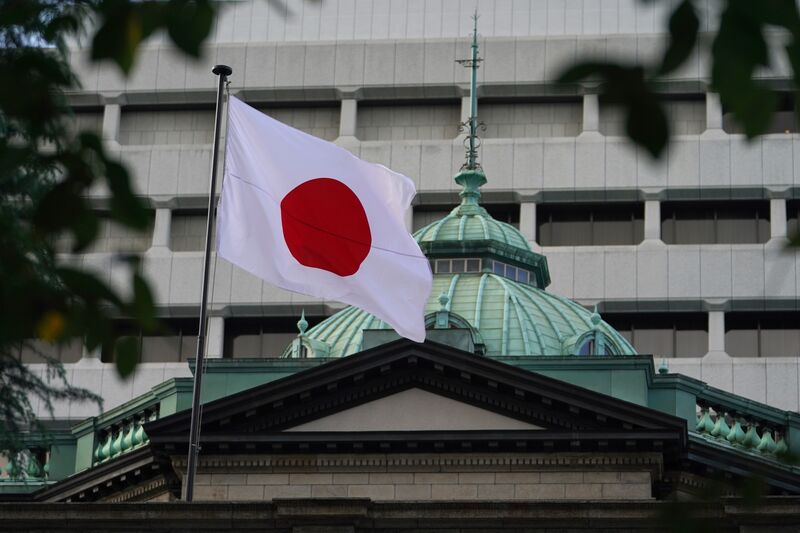 A Japanese national flag flies outside the Bank of Japan headquarters in Tokyo,  Sept. 27, 2021. 