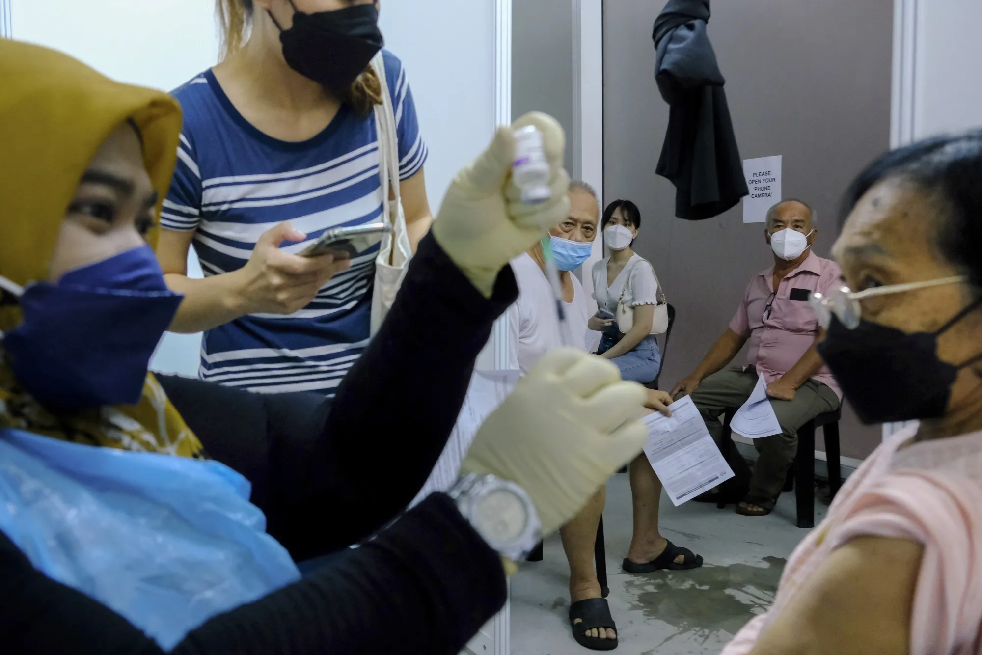 Members of the public wait to receive Covid-19&nbsp;booster shots&nbsp;in Selangor, Malaysia.