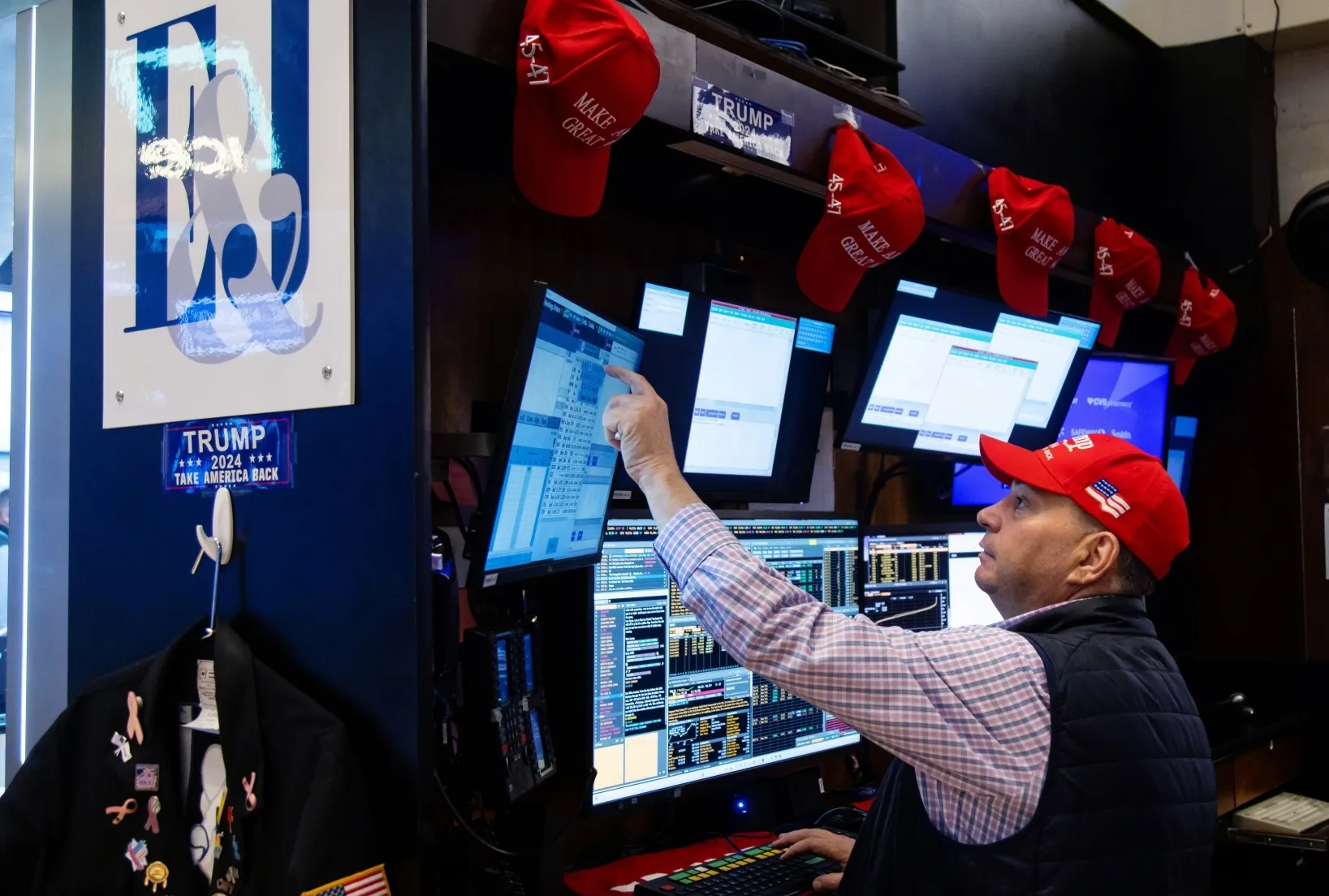 A trader wearing a Trump hat works on the floor of the New York Stock Exchange.